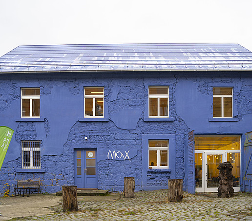 Ein blaues Haus mit weißen Fensterläden.