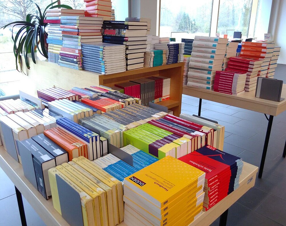 mit Bücherstapeln gefüllte Tische