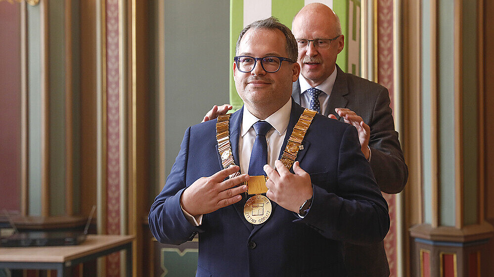 Prof. Drossel hängt Prof. Kratzsch die Amtskette im Bürgersaal um.
