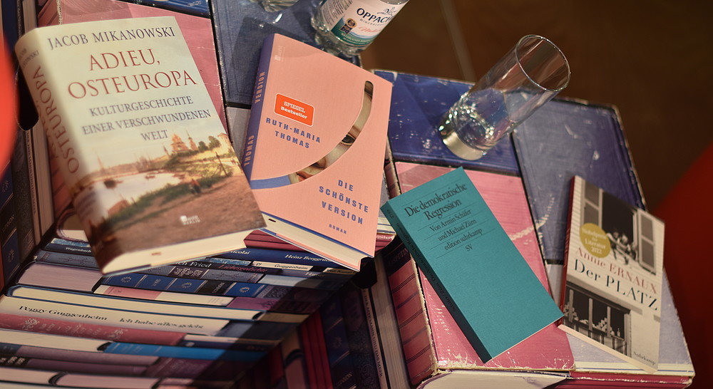 Vier Bücher liegen dekorativ ausgestellt da.