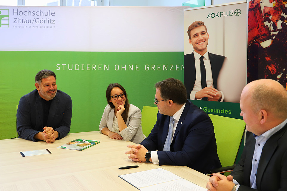 AOK Plus-Gäste und Rektor und Kanzler sitzend und diskutierend im Beratungssaal