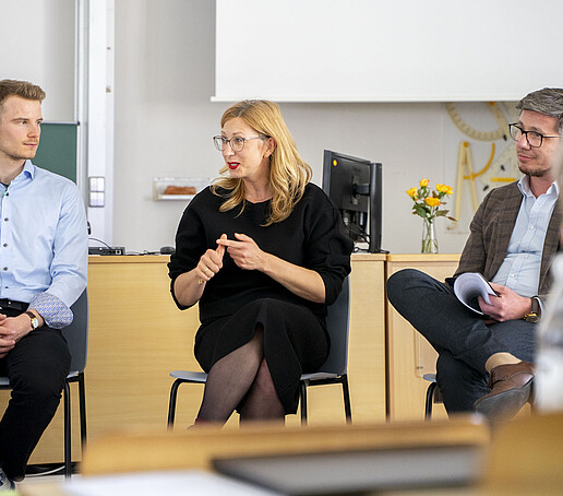Eine diskussionsteilnehmende Professorin spricht ins Mikrofon.