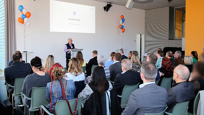 Prof. Hasinger am Rednerpult hält einen Vortrag vor vollen Sitzreihen.