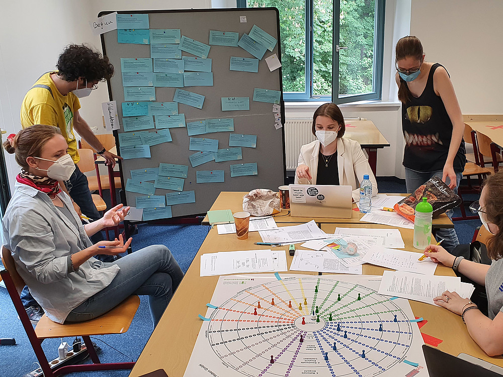 Gruppe Studierender am Tisch mit Brettspiel